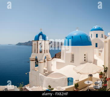 A stitched panorama of a couple of the famous blue domed churches from Oia on the greek isle of Santorini. Stock Photo