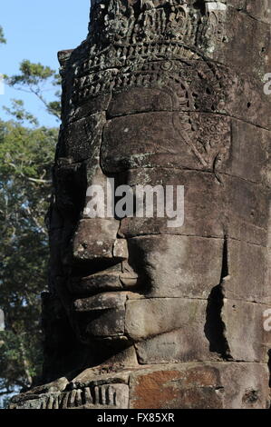 sunlit giant face of The Bayon, Angkor Thom, Temples of Angkor, Siem Reap Province, Cambodia. credit: Kraig Lieb Stock Photo