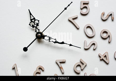 Time concept. Minute and second hands near set of wooden digits Stock Photo