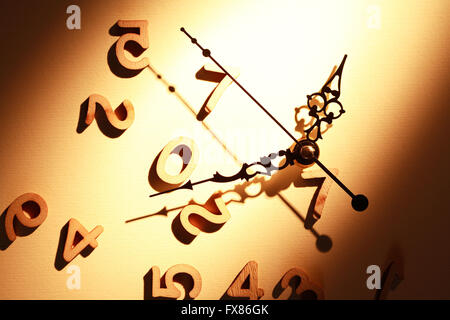 Time concept. Clock face near set of wooden digits Stock Photo