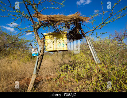 Beehive fence of African bee hives designed to deter elephants from raiding crops on a farm near Voi in Southern Kenya Stock Photo