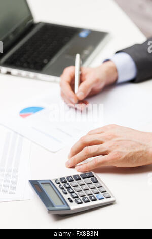 close up of businessman with laptop and papers Stock Photo