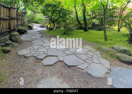 Stone Path Walkway with bamboo fence and landscaping at Japanese Garden Stock Photo
