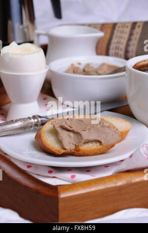 A slice of toast spread with liver pate for breakfast  on a tray Stock Photo