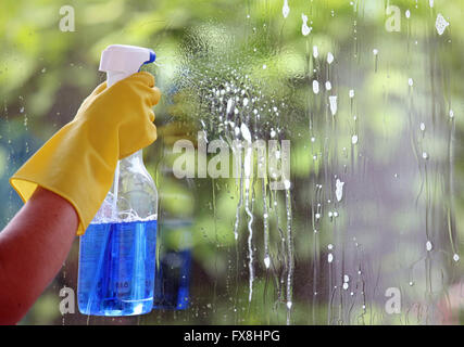 A woman is cleaning her windows Stock Photo