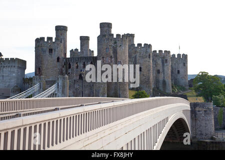 Close up view of Conway Conwy Castle in North Wales with the road bridge in the foreground and old suspension bridge behind Stock Photo