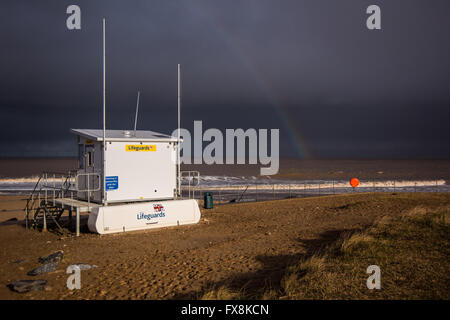 R.N.L.I Lifeguards Station faces a rainstorm over the North Sea seen from The Promenade, Skegness, Lincolnshire, England, UK. Stock Photo
