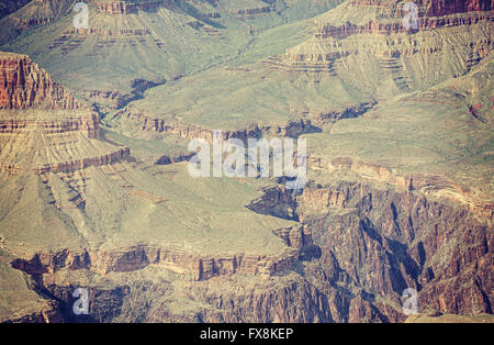 Vintage toned photo of a helicopter carrying load over Grand Canyon, Arizona, USA. Stock Photo