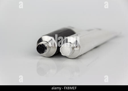 black and white paint tubes closeup on white background Stock Photo
