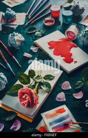 Painting flowers: stains and sketches. Still life with artist's tools and flowers Stock Photo