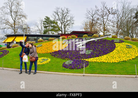 Tourists taking selfie photograph in front of Flower Clock, Geneva Stock Photo