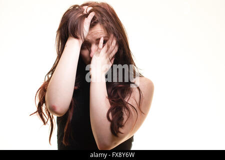 Depression and loneliness: A sad depressed young woman girl hiding her face in her hands