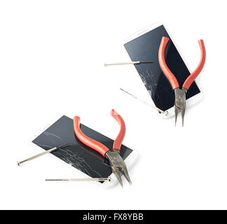 Pliers and screwdriver over the broken phone Stock Photo