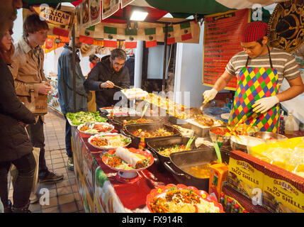 People buying mexican food at a street food stall, Brick Lane Sunday Upmarket, Spitalfields, London East End, UK Stock Photo