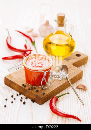 Jar of piquant sauce made from chili peppers and garlic Stock Photo