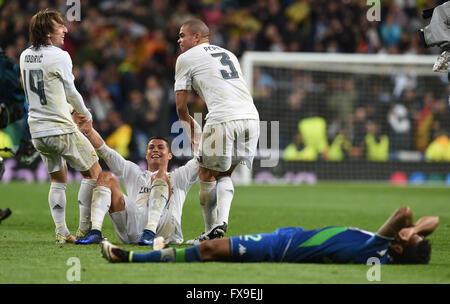 Madrid, Spain. 12th Apr, 2016. Cristiano Ronaldo (2nd L) of Madrid celebrates with Luka Modric (L) and Pepe the 3-0 victory of his team after the UEFA Champions League quarterfinal second leg soccer match between Real Madrid and VfL Wolfsburg at the Santiago Bernabeu stadium in Madrid, Spain, 12 April, 2016. Wolfsburg's Luiz Gustavo (ront) lays dejected on the ground. Photo: Carmen Jaspersen/dpa/Alamy Live News Stock Photo