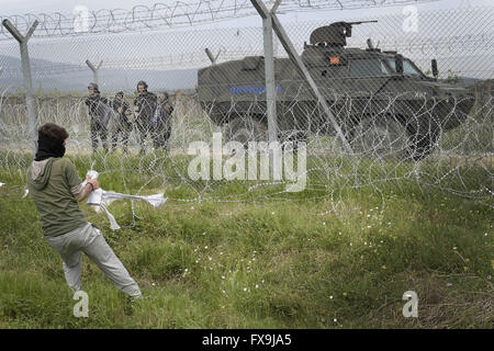 Eidonemi, Greece. 13th Apr, 2016. Greece/Macedonia border Idomeni/Gevgelija April 13 2016:hundreds of migrants have tried today to break through the barrier that divides them from Macedonia, the police responded with tear gas, rubber bullets and sound bombs after the migrants have managed to break through the fence. dozens injured and intoxicated by tear gas. Credit:  Danilo Balducci/ZUMA Wire/Alamy Live News Stock Photo