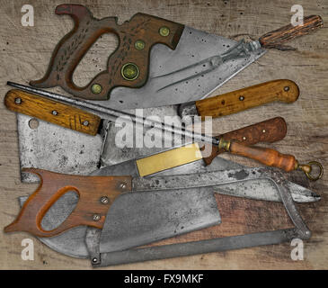 vintage butcher shop tools and utensils over stained wooden table Stock Photo