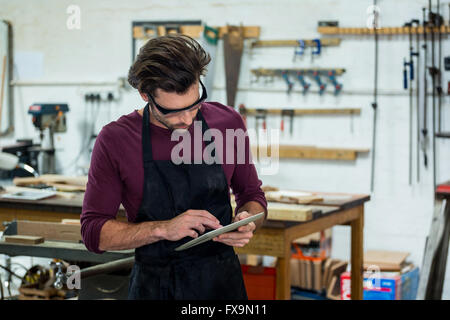 Carpenter is using his tablet Stock Photo