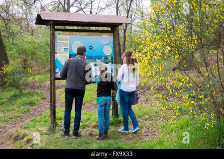 young family studying park map in Manziana, Italy Stock Photo