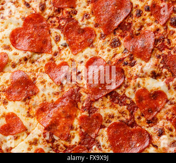 Heart shape Pepperoni Pizza close up background Stock Photo