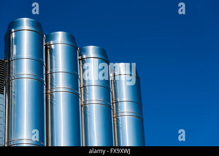 shiny chrome pipes against the blue sky Stock Photo