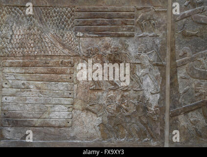 Slab. Transportation of timber (cedars of Lebanon). Men are pulling a load with a rope. Palace of Sargon II. Khorsabad. Iraq. Stock Photo