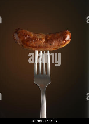Sausage on fork Stock Photo
