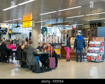 People at coffee bar waiting at Schiphol Amsterdam Airport, Netherlands