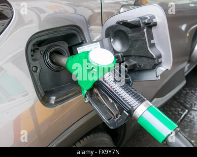 Close-up of unleaded gas pump nozzle refilling the car in petrol station in the Netherlands Stock Photo