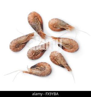Unpeeled brown shrimps on white background Stock Photo