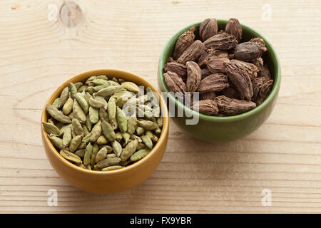 Bowls with green and large black Cardamom seeds Stock Photo