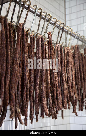 Cured biltong hanging from meat hooks Stock Photo - Alamy