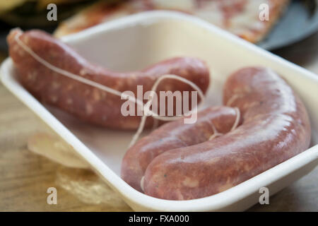 raw pork sausages in a polystyrene tub Stock Photo