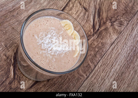 Chocolate drink with coconut and banana on a wooden background Stock Photo