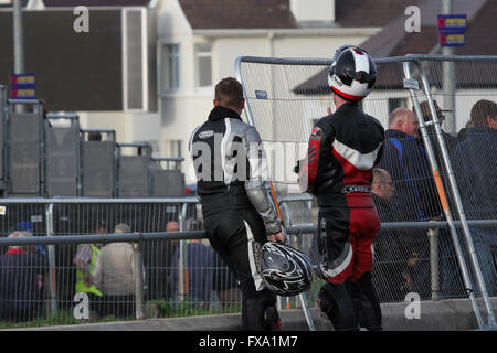 Thursday 13th May 2014 - Vauxhall International North West 200. Evening races - two motorbike enthusiasts enjoy the break before another race on the famous Triangle Circuit, last race of the evening. Stock Photo