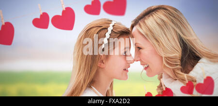Composite image of happy mother with daughter looking each other against white background Stock Photo