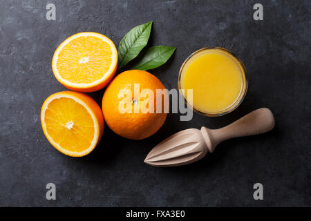 Oranges and juice glass on stone background. Top view Stock Photo