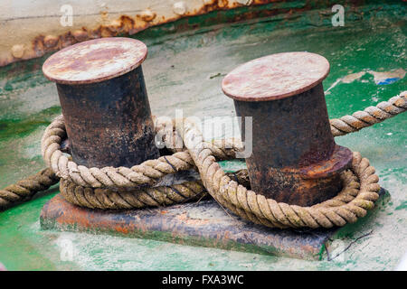 Old mooring bollard with heavy ropes, closeup. Stock Photo