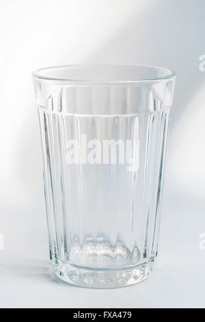 Empty faceted glass on gray background Stock Photo