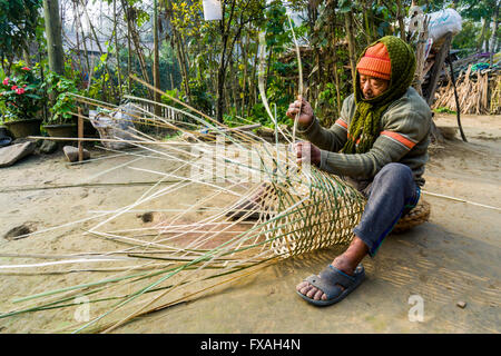 A man is weaving a bamboo basket, Sauraha, Chitwan, Nepal Stock Photo