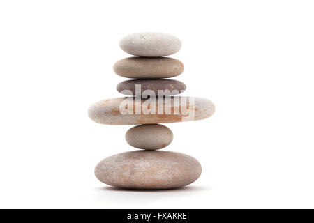 Pile of balancing pebble stones, like ZEN stone, isolated on white background, spa tranquil scene concept Stock Photo