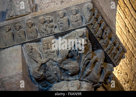 Right capital from the Arc de Triomphe with scenes of angels and of Adam and Eve in the garden,in the interior of the Romanesque Stock Photo