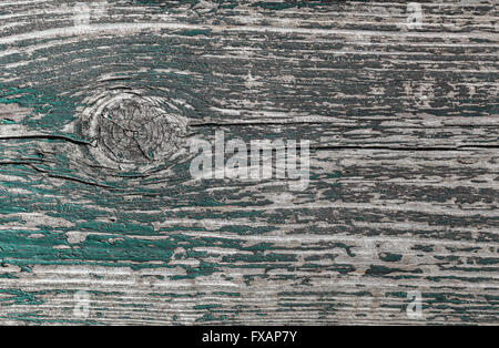 Wood board eroded by time, with green peeling paint. Stock Photo