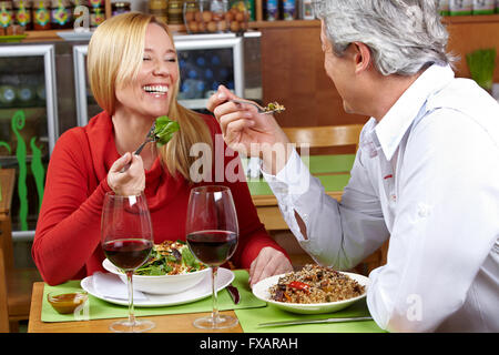Happy senior couple having dinner together in a restaurant Stock Photo