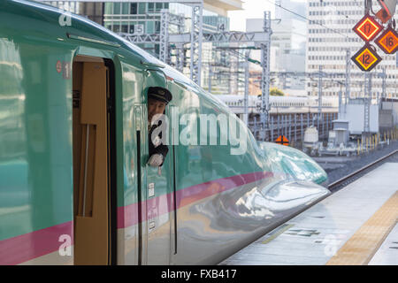 Tokyo, Japan - December 23, 2014: A Shinkansen train operator looking out of the window before departure. Stock Photo