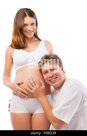 Husband listening to his wife's belly Stock Photo