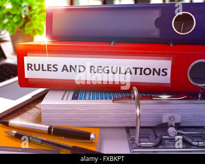 Rules And Regulations on Red Ring Binder. Blurred, Toned Image. Stock Photo