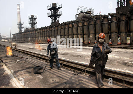 Huaibei, Huaibei, CHN. 13th Apr, 2016. Huaibei, CHINA - April 13 2016: (EDITORIAL USE ONLY. CHINA OUT) Coke oven workers step on the 1000-degrees-Celrius coke oven. It is totalling a flaming mountain here. They take coal out, load coal, push coke, block, sweep and dust, furnace temperature, open and close the riser, and tamp briquettes, push coke on trucks, trains, stop the coke car. Coal industry depresses now and influences their payment. But they still work off steam. © SIPA Asia/ZUMA Wire/Alamy Live News Stock Photo