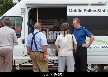 Male PCSO discusses home security with members of the public Stock Photo